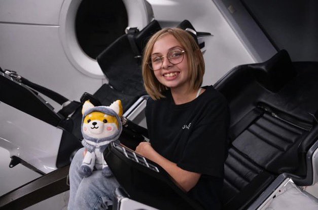 Liv Perrotto inside the SpaceX Dragon capsule holding Asteroid